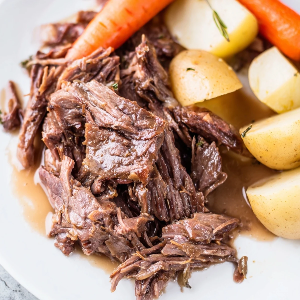 Hearty Slow Cooker Beef Roast plated with celery and onions, drizzled with rich pan juices for dinner.