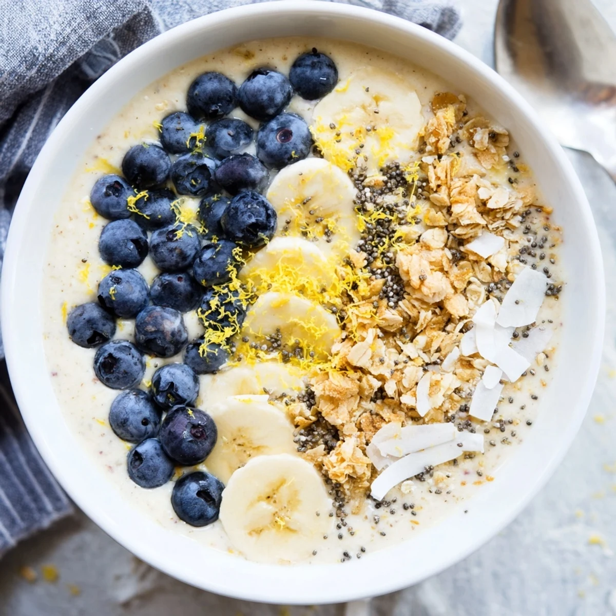 Two vibrant Lemon Blueberry Smoothie Bowls ready to serve, featuring creamy yogurt swirls and crunchy granola for a nourishing breakfast.