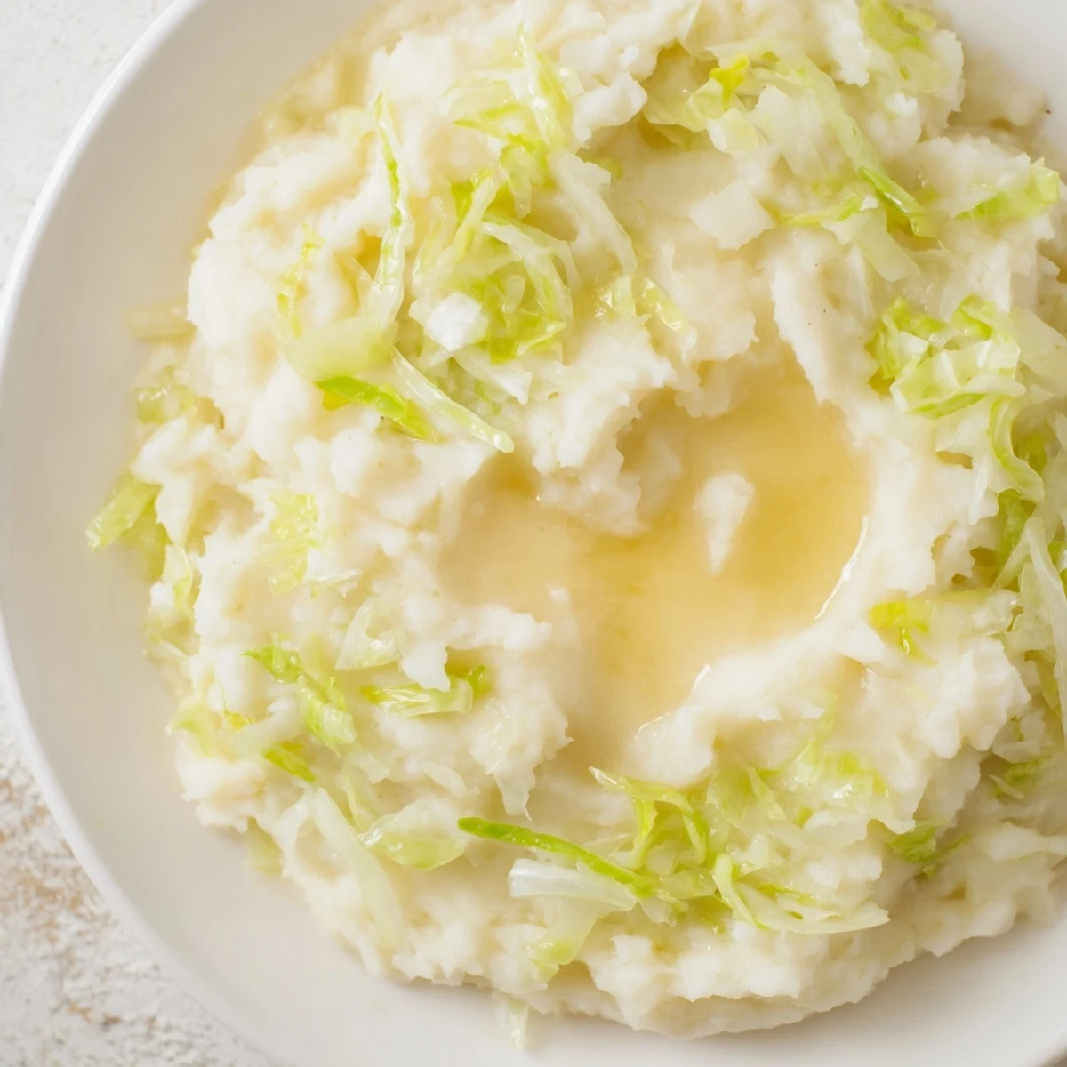 A bowl of fluffy St. Patricks Day Colcannon Mashed Potatoes, blending tender cabbage and scallions for a hearty Irish side.