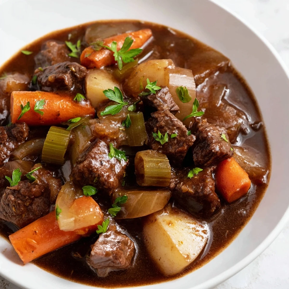 Hearty Dutch oven of Guinness-Style Alcohol-Free Beef Stew, simmered with carrots and parsnips, ready to serve.