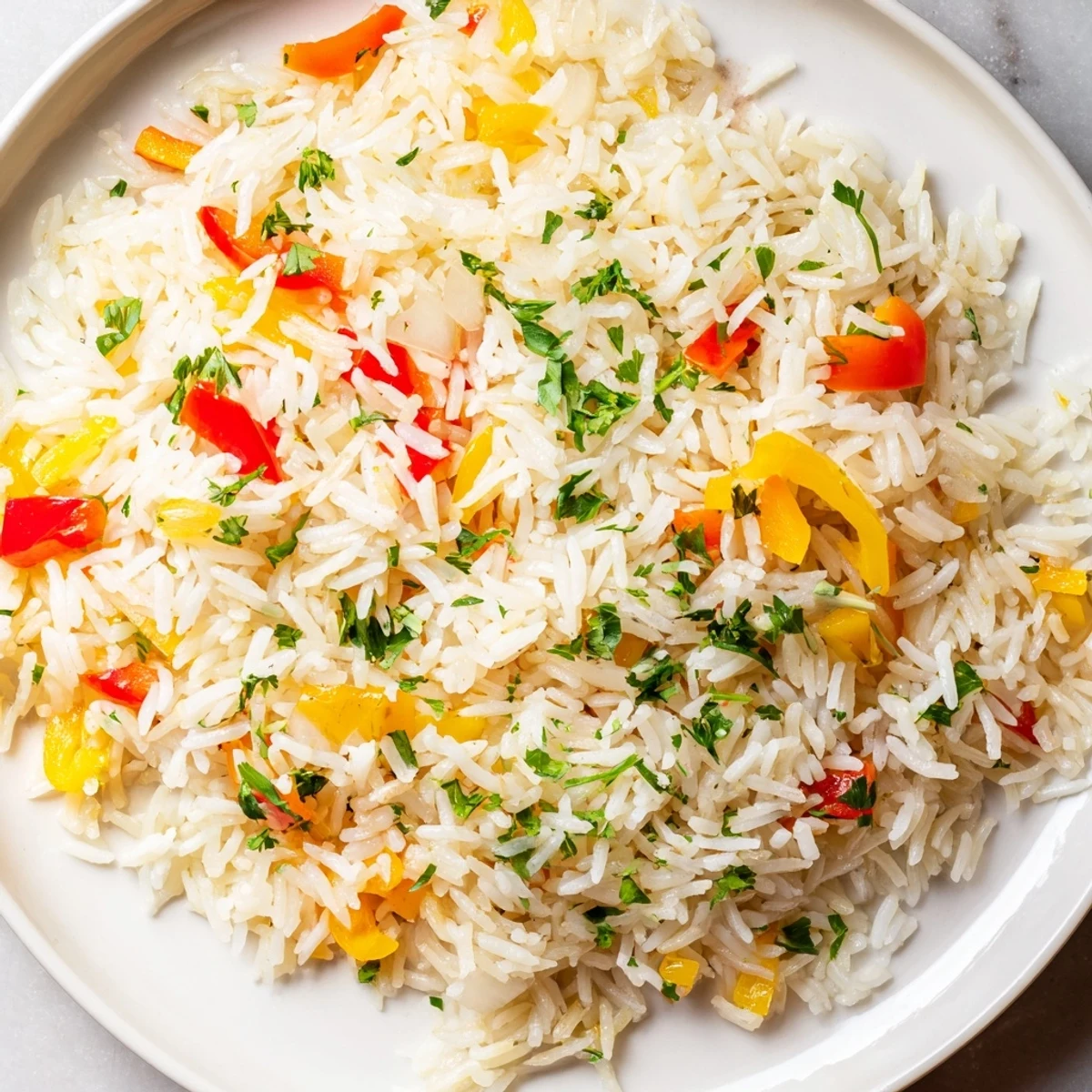 Steaming rice pilaf with peppers and onions in a colorful skillet, garnished with fresh parsley.  
