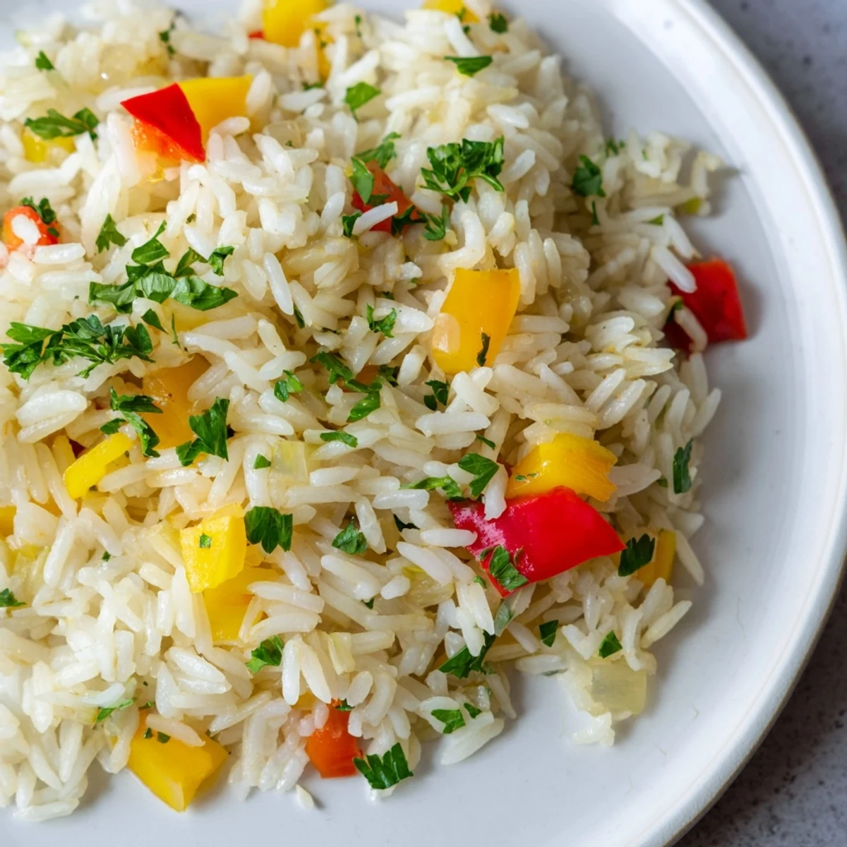 Fork lifting fluffy rice pilaf with peppers and onions, highlighting the tender vegetables and herbs.