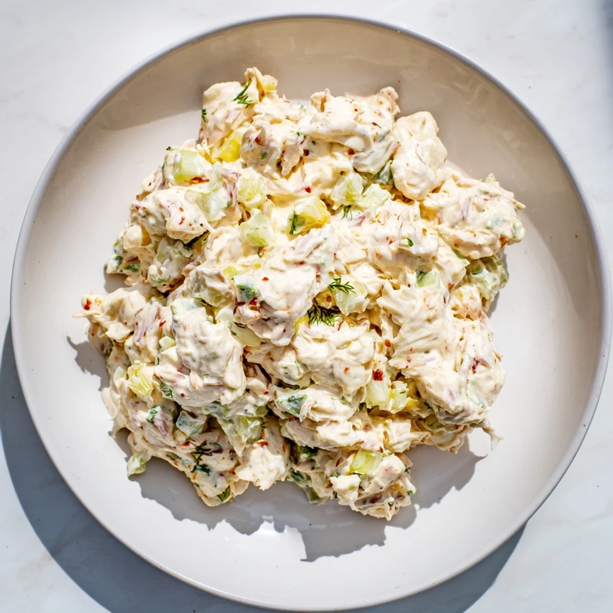 Zesty remoulade sauce studded with celery and capers, folded with tender lump crab meat for a French-American appetizer.  