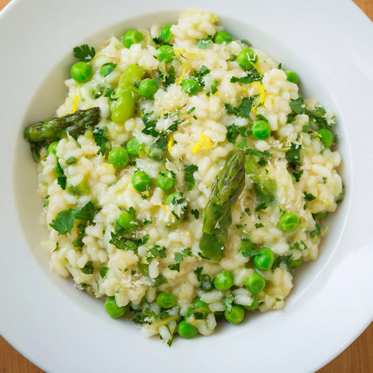 Steam rises from a creamy bowl of Spring Pea and Asparagus Risotto garnished with fresh parsley.