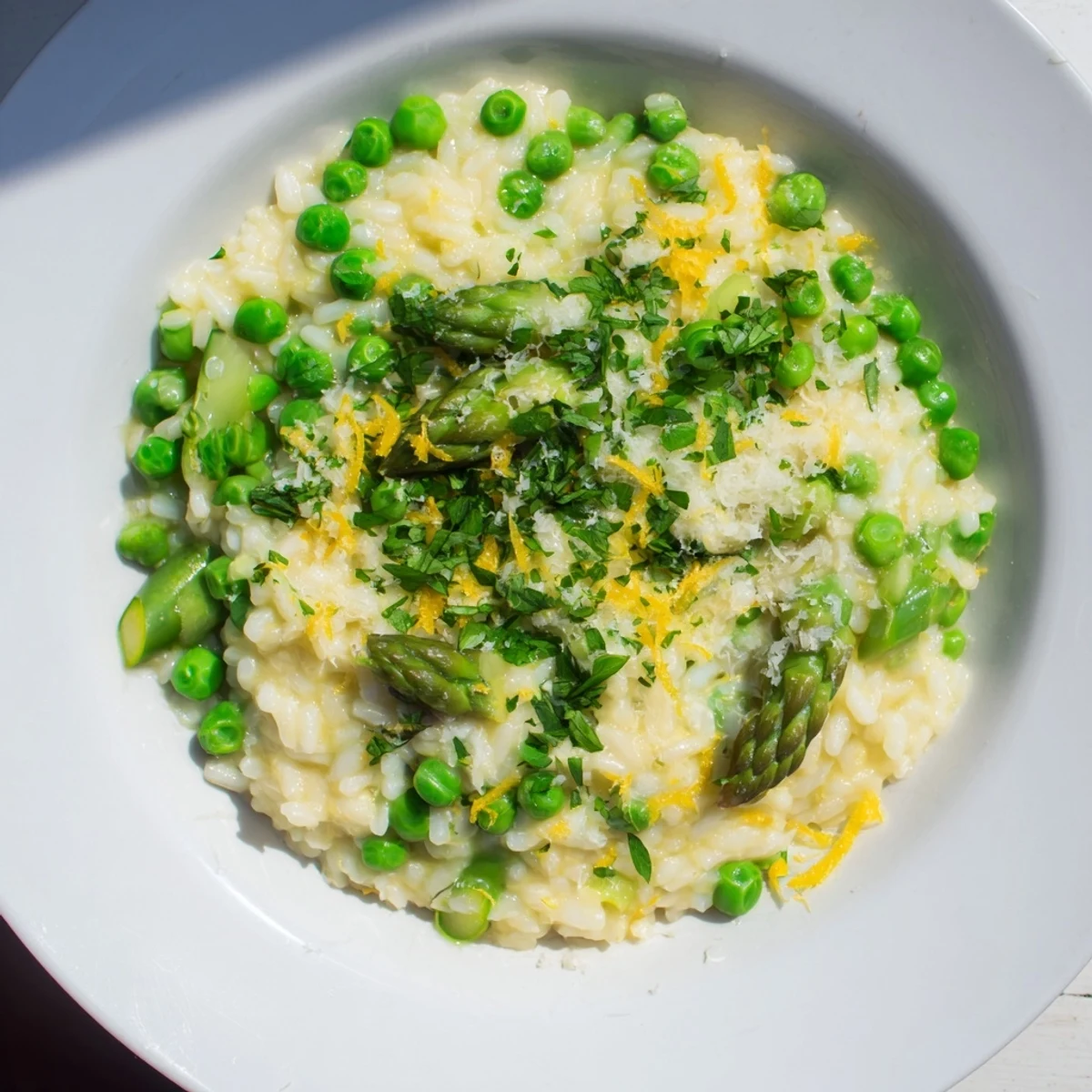 Serve Spring Pea and Asparagus Risotto in shallow bowls topped with extra Parmesan for a bright spring meal.