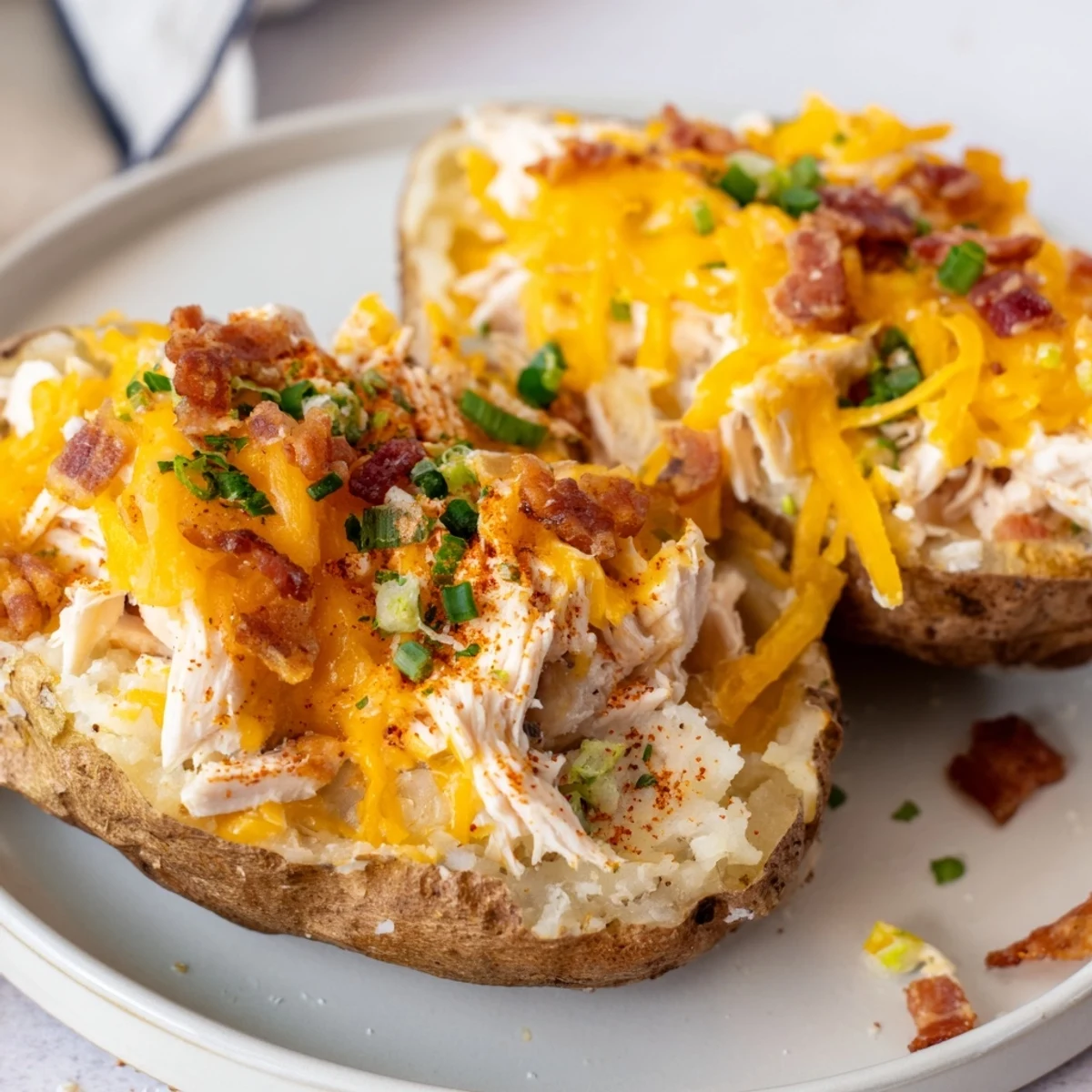 Steaming twice baked potatoes with a rich chicken filling, garnished with fresh parsley and served as a hearty main dish.