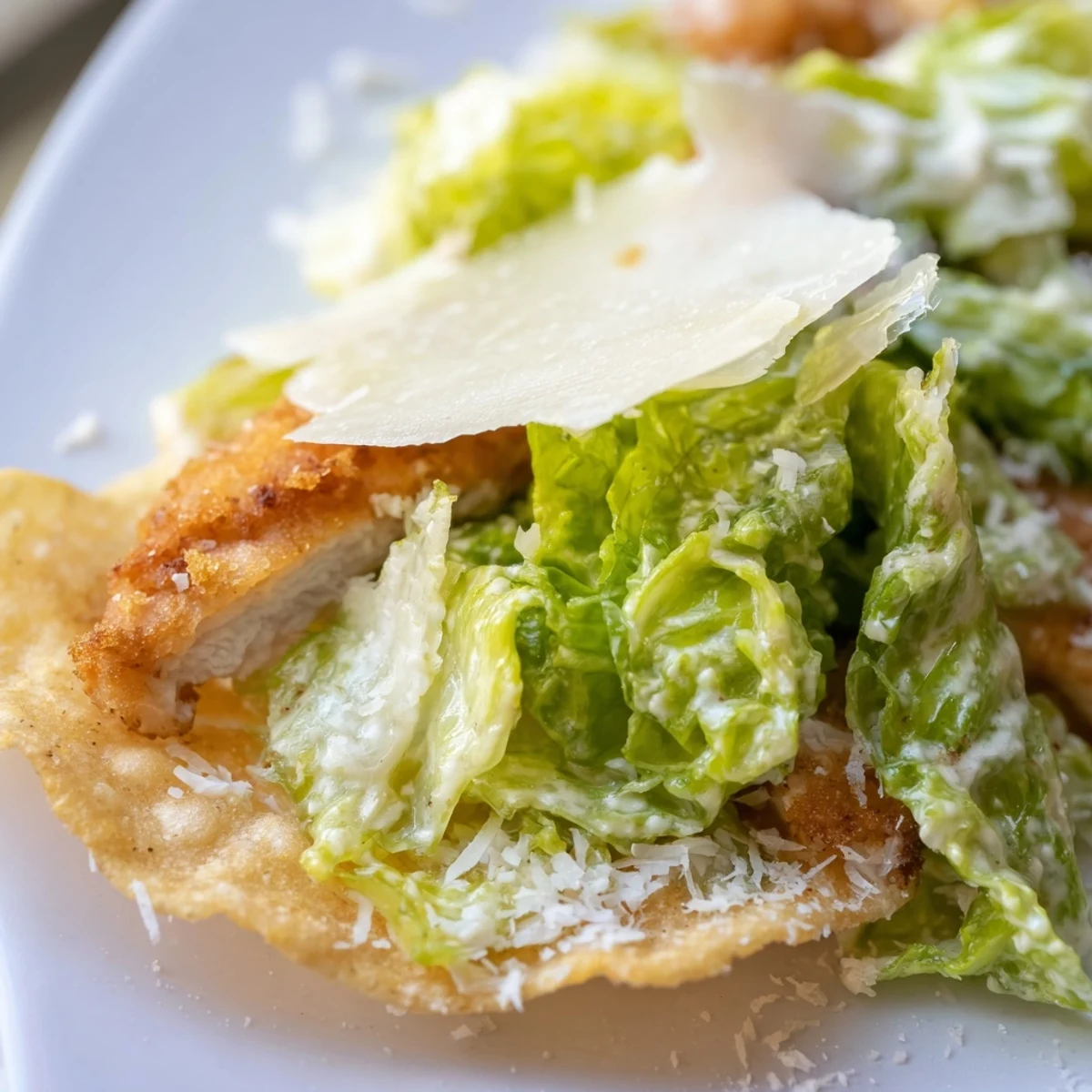 Crispy Chicken Caesar Salad Chips display crunchy golden potato chips topped with shredded romaine and grilled chicken pieces.