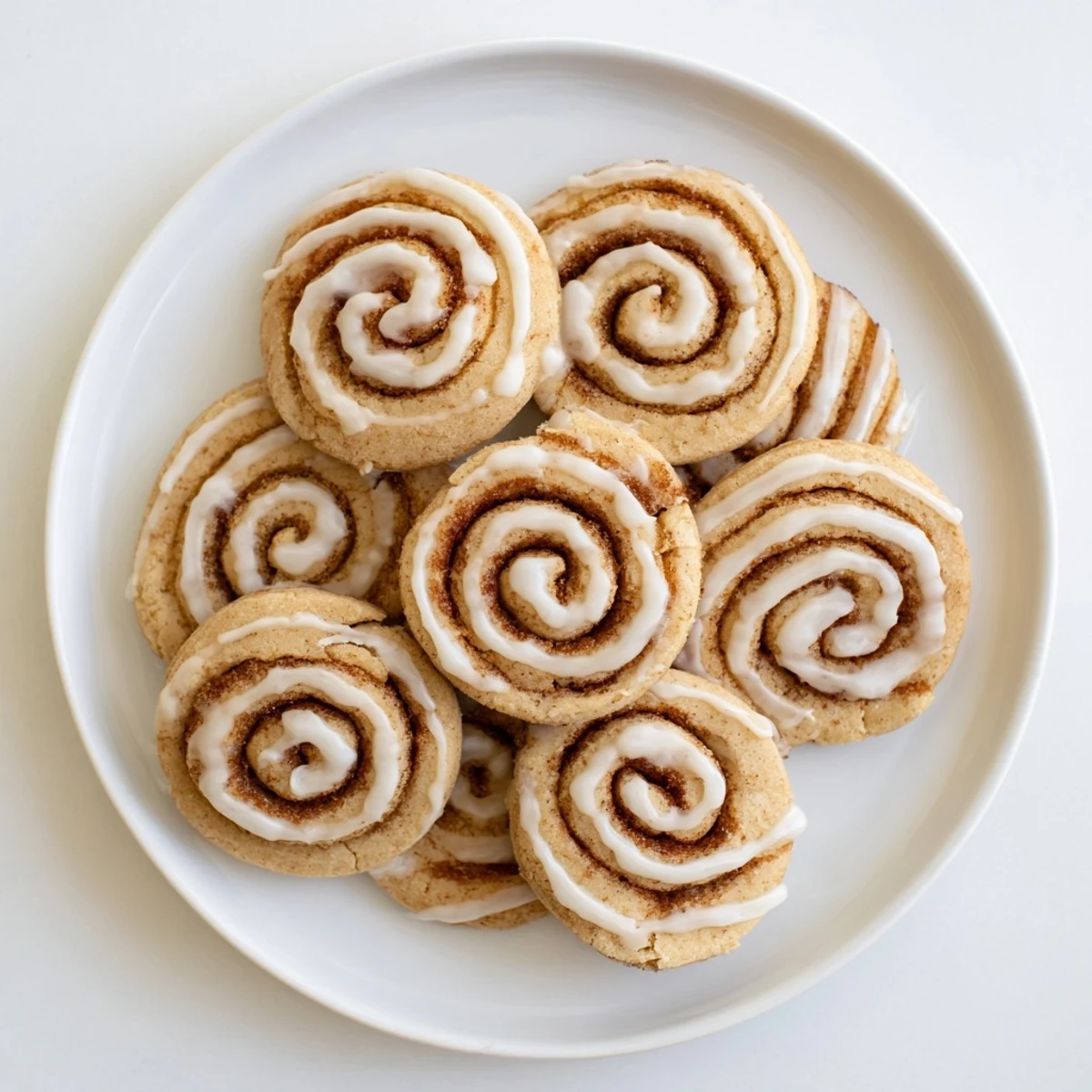 A close-up of a Cinnamon Roll Cookie showing cinnamon sugar swirl and soft buttery texture.