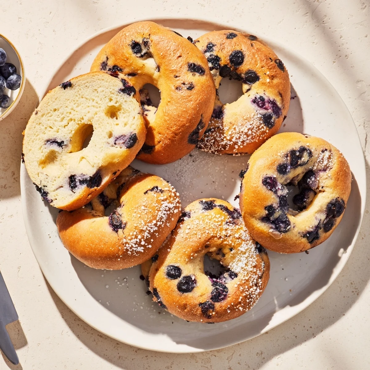 Golden-brown Gluten-Free Blueberry Bagels cooling on a wire rack, ready for toasting.