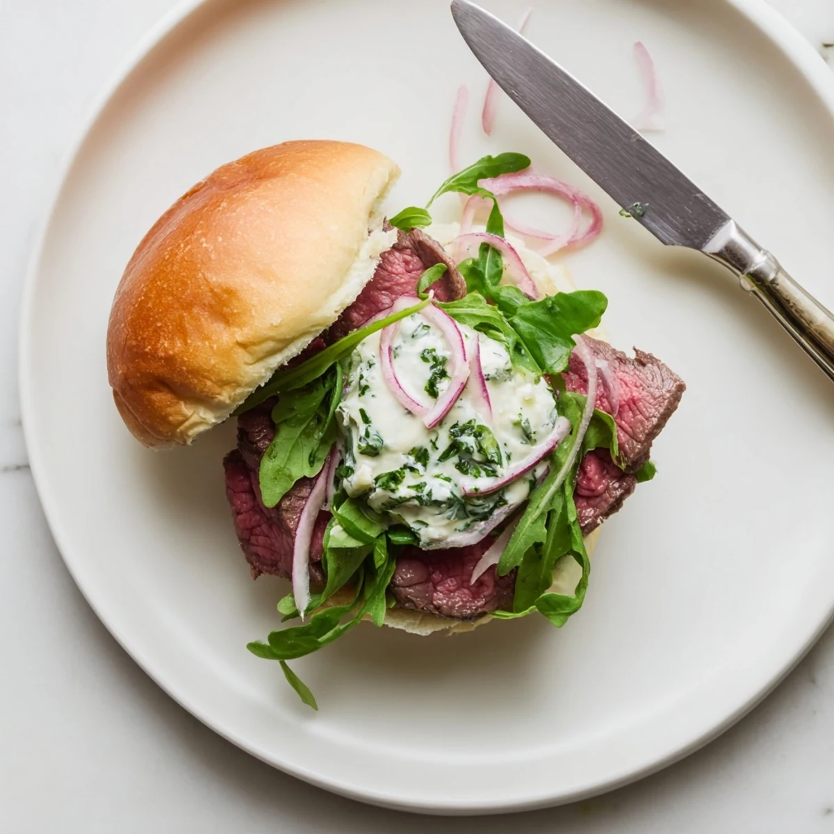 Juicy Cowboy Butter Steak Sliders with tender grilled steak, arugula, and melted butter sauce on soft buns.
