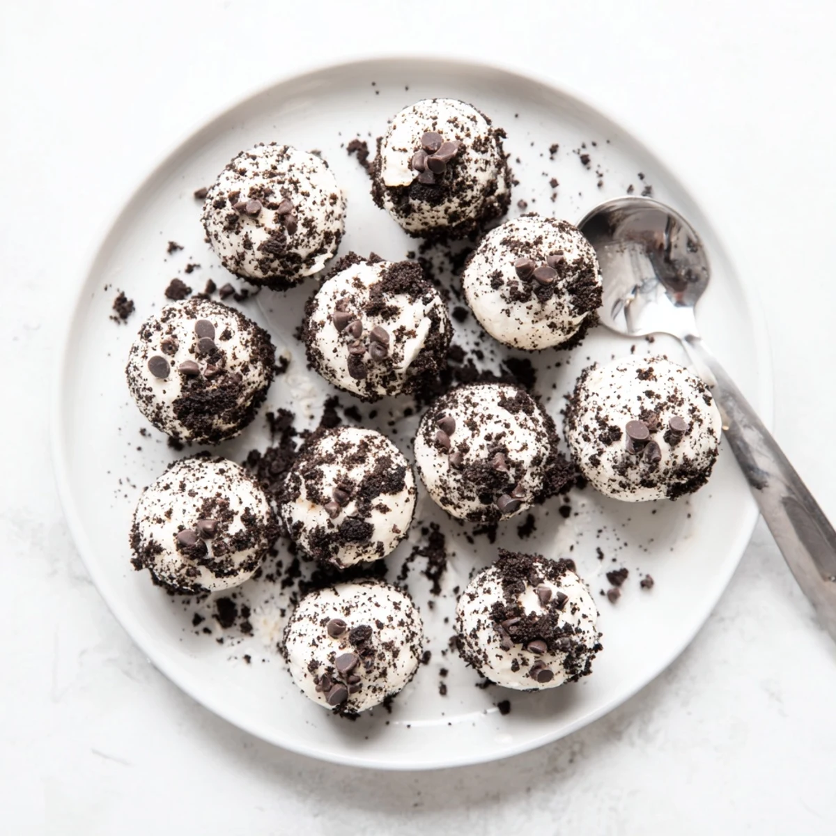 Crumbled Oreo topping on Cream Cheese Oreo Protein Balls with a creamy filling, perfect for a post-workout treat.