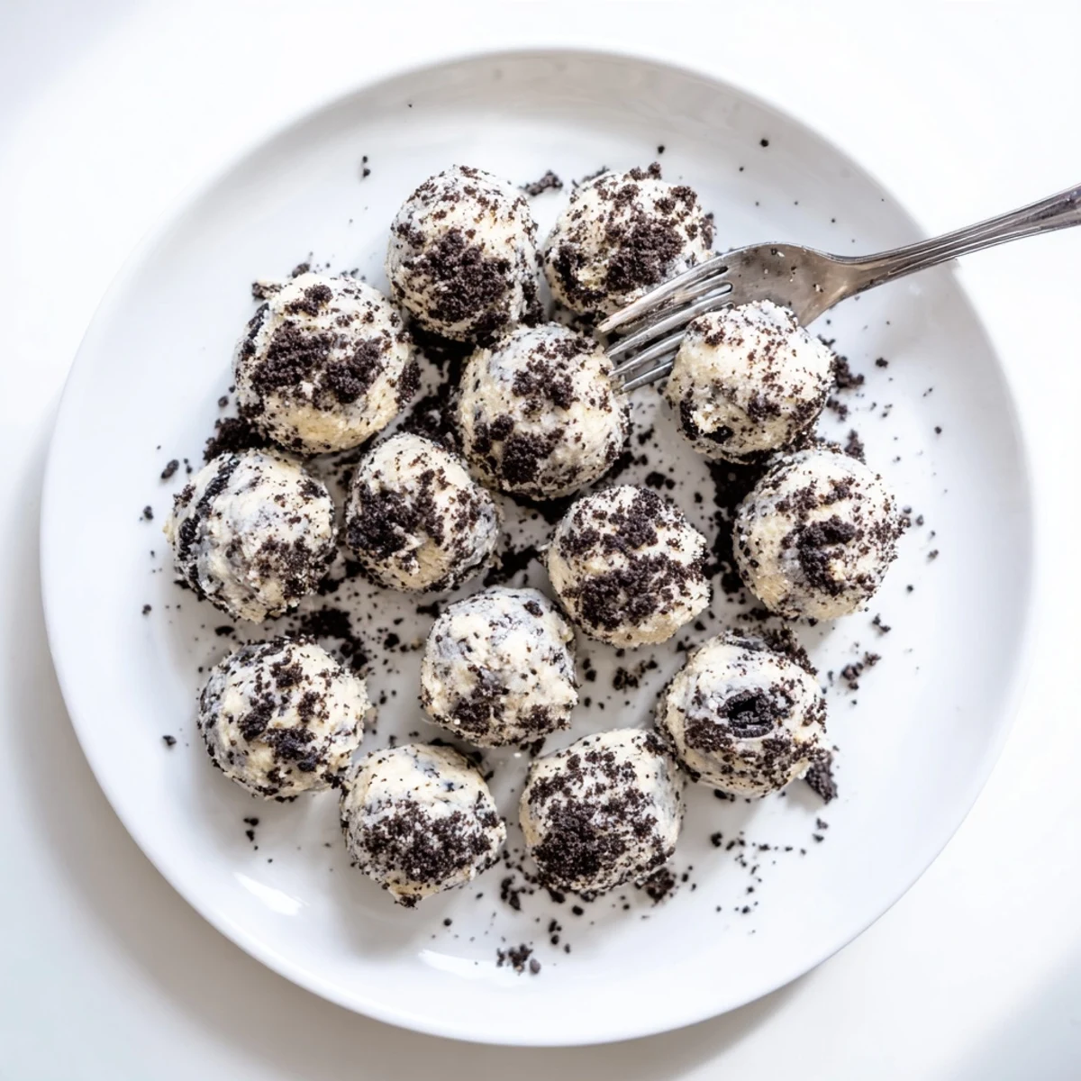 A close-up of Cream Cheese Oreo Protein Balls rolled in dark crumbs, ready for a quick snack or dessert.
