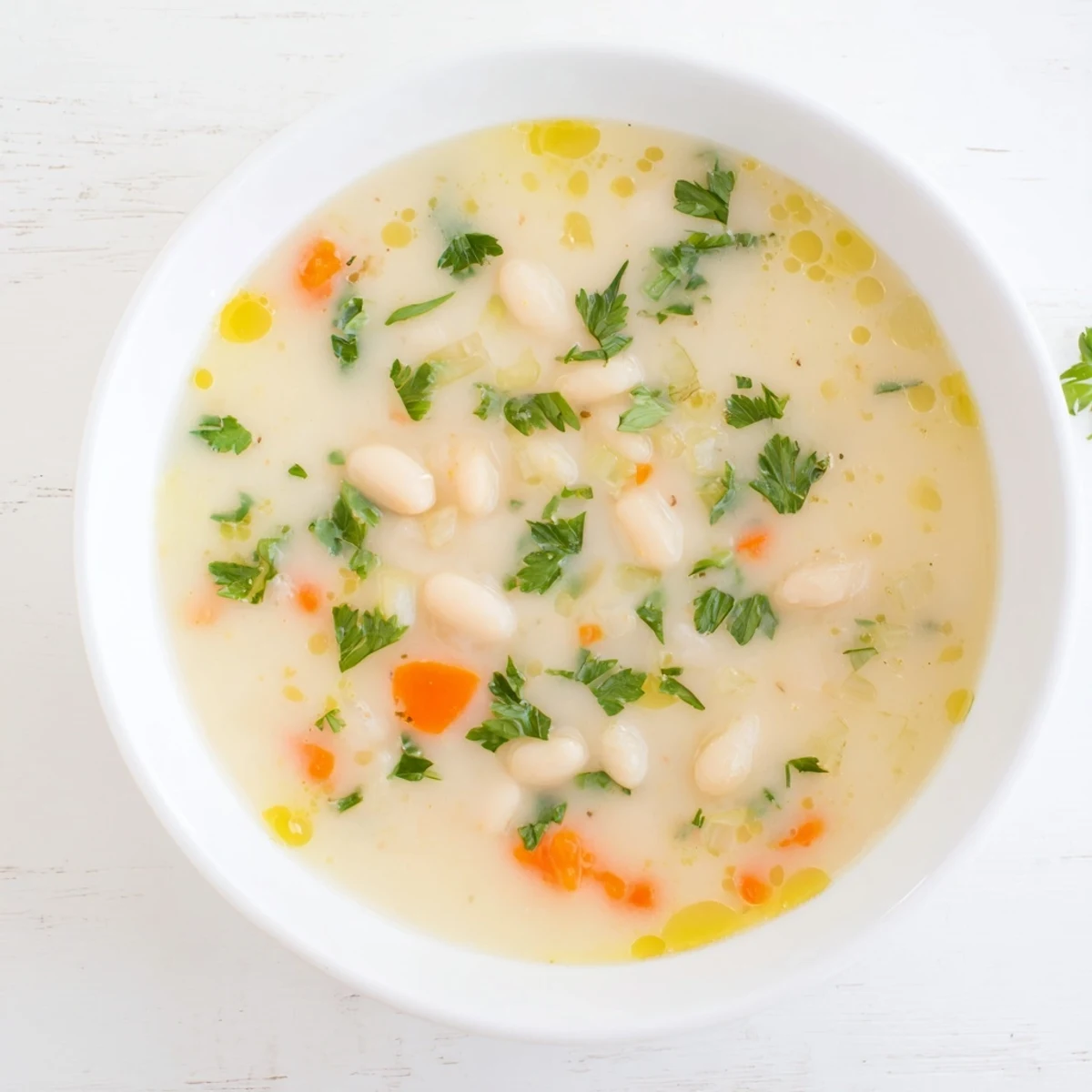 Creamy white bean soup simmered with fragrant rosemary and garlic in a rustic earthenware bowl