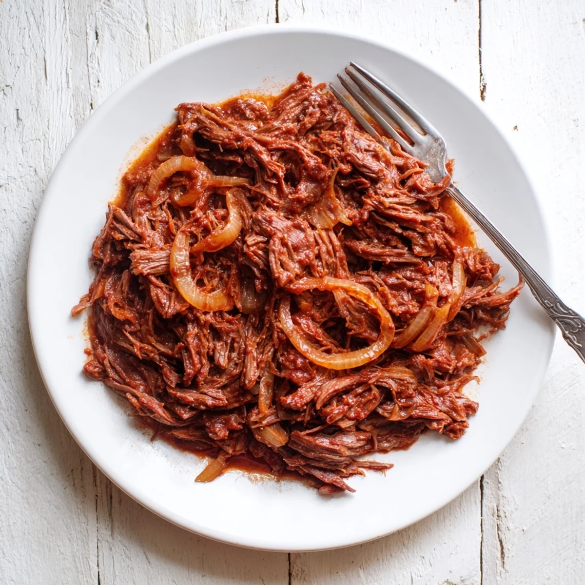 Slow-cooked Crock Pot shredded beef featuring perfectly seasoned fork-tender meat in rich broth