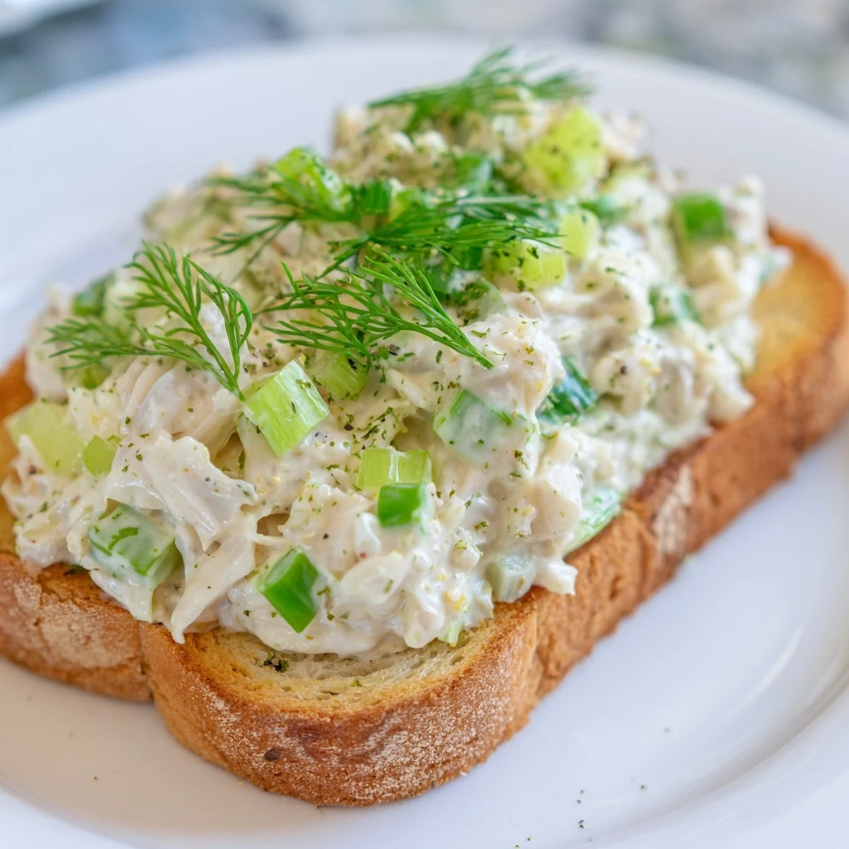 Crispy appetizer toast with zesty crab salad and celery garnish