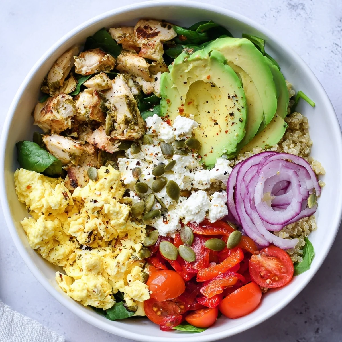Hearty easy high protein breakfast bowl topped with cottage cheese eggs, cherry tomatoes, and pumpkin seeds