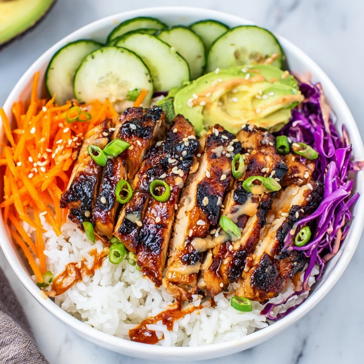 Colorful Korean BBQ chicken bowl featuring glazed grilled chicken over rice with fresh vegetables and spicy gochujang mayo drizzle