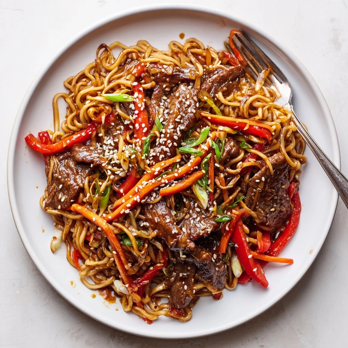 Weeknight Sticky Beef Noodles served steaming in a wok, with honey aroma