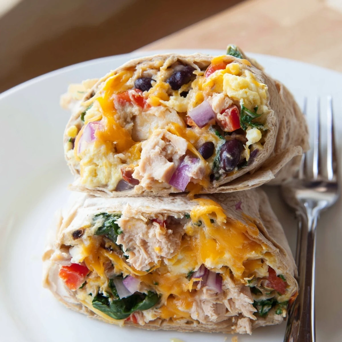 Hearty Protein Breakfast Burrito with turkey, black beans, sauteed red peppers, spinach.