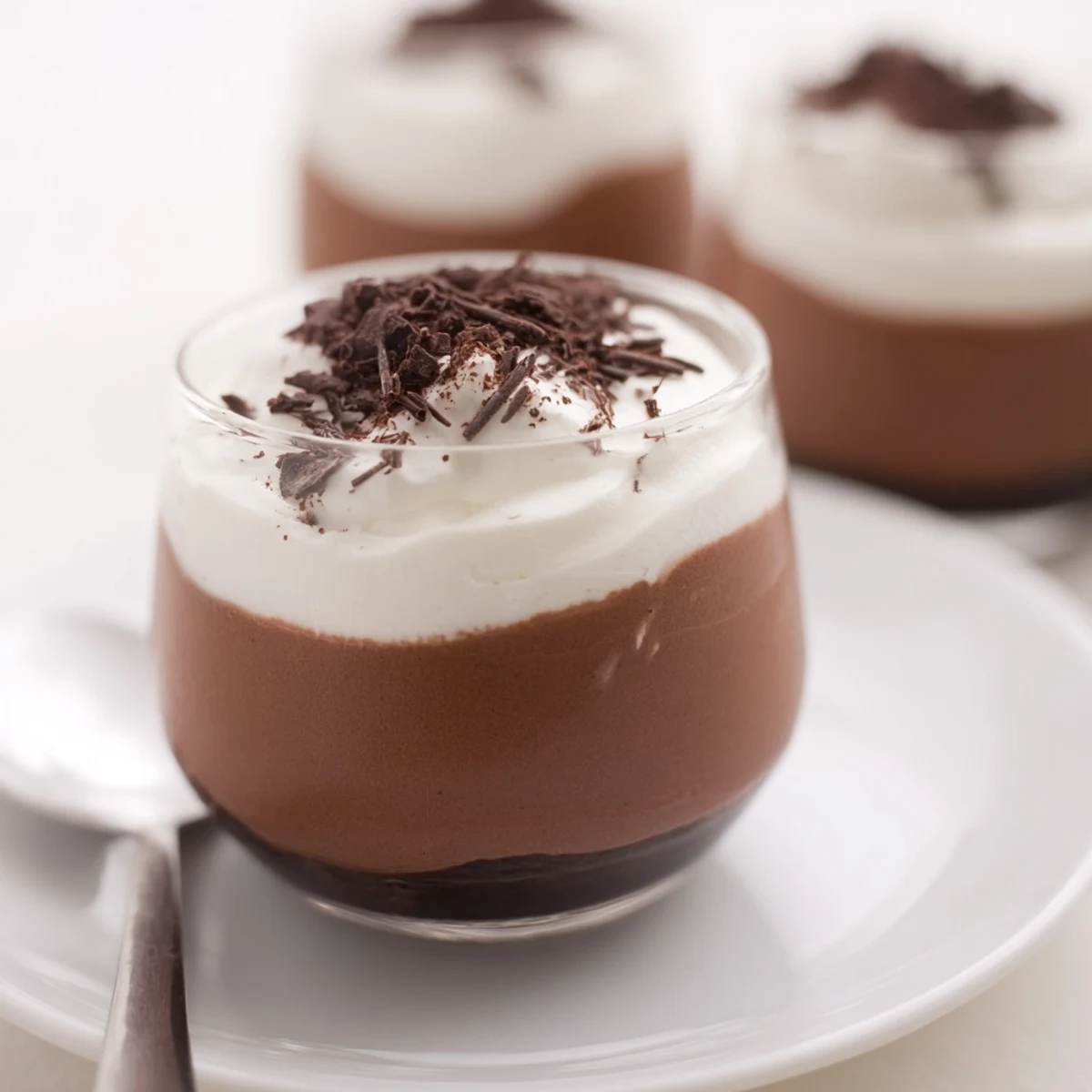 Individual Triple Chocolate Mousse Cups garnished with cocoa dust, creamy, pillowy layers.