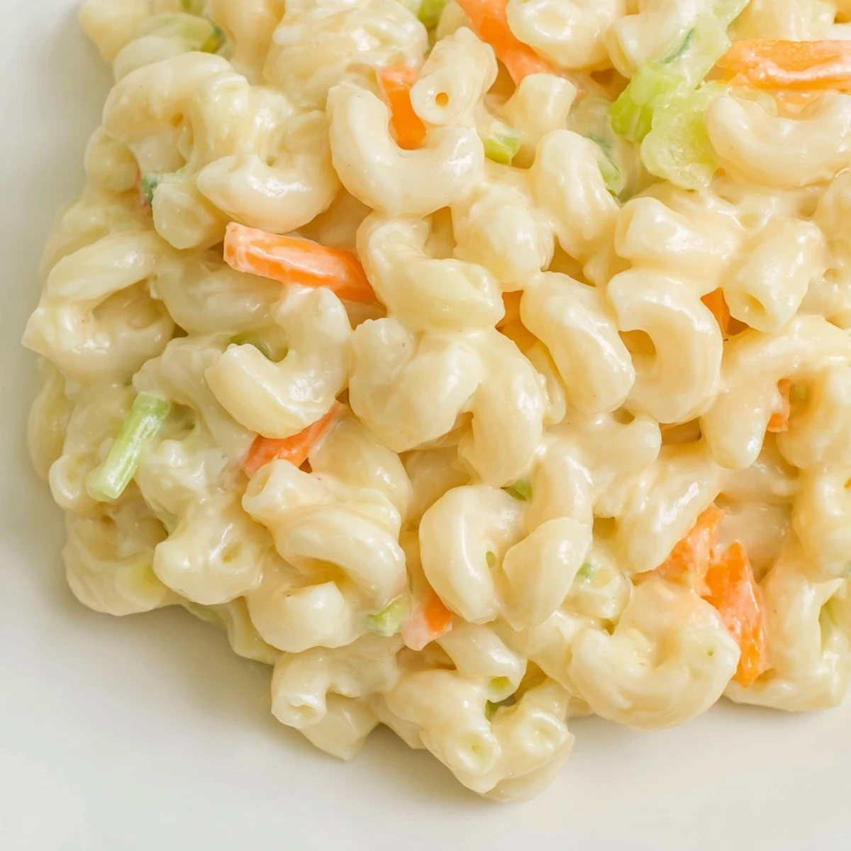 Creamy Hawaiian style mac salad loaded with tender macaroni, grated carrots, and crunchy celery in a tangy mayonnaise dressing