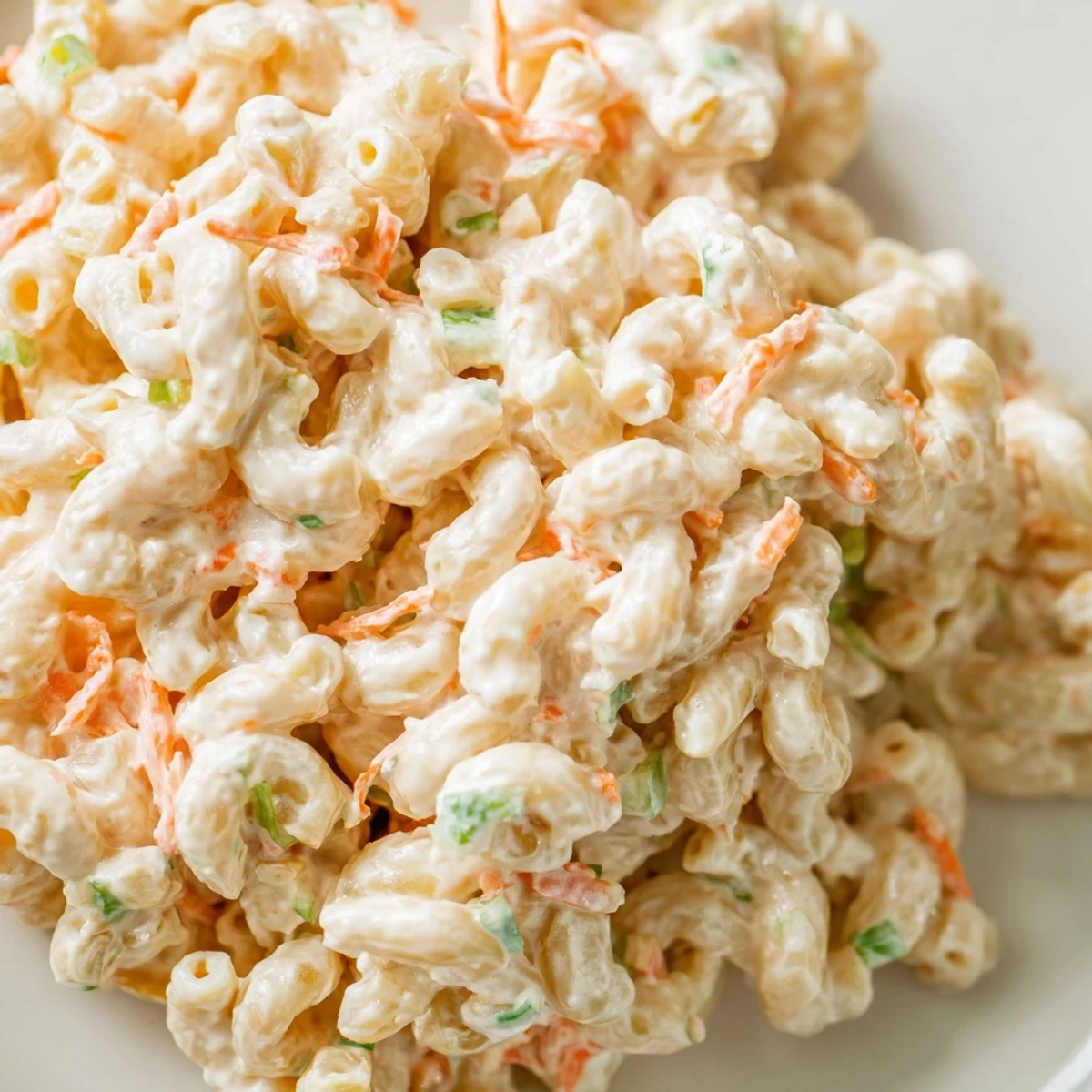 Golden Hawaiian style mac salad featuring extra soft pasta noodles tossed in a smooth vinegar spiked creamy dressing