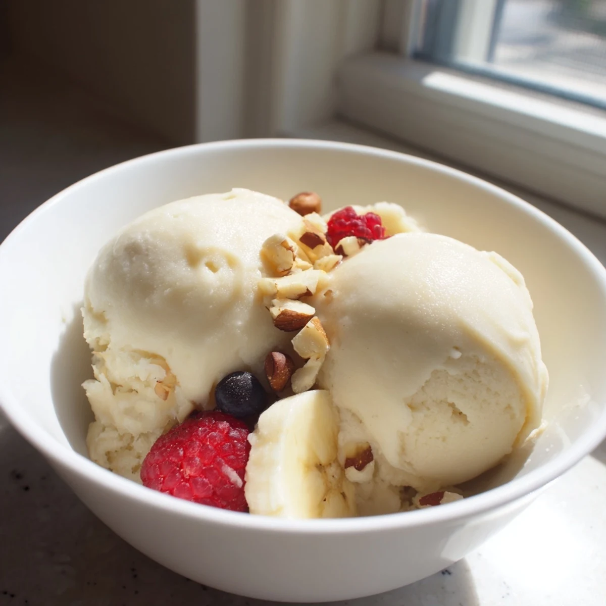 Vegan banana-based healthy nice cream swirling with berries and cocoa variations in a glass