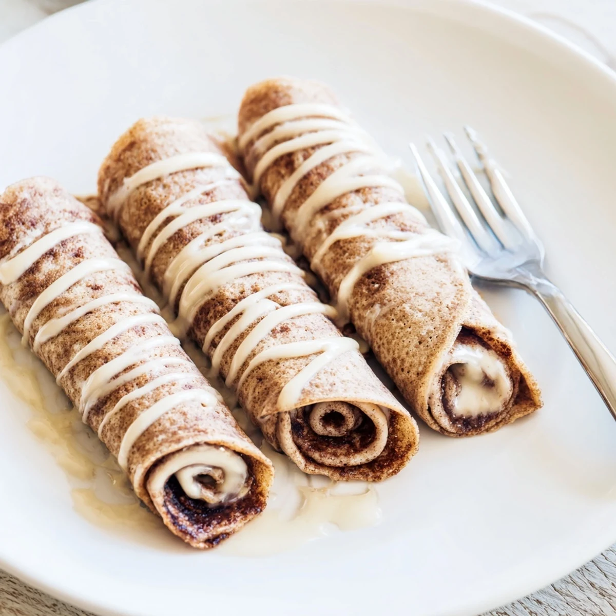 Golden Cinnamon Roll Protein Crepes rolled with spiced cinnamon filling and served fresh