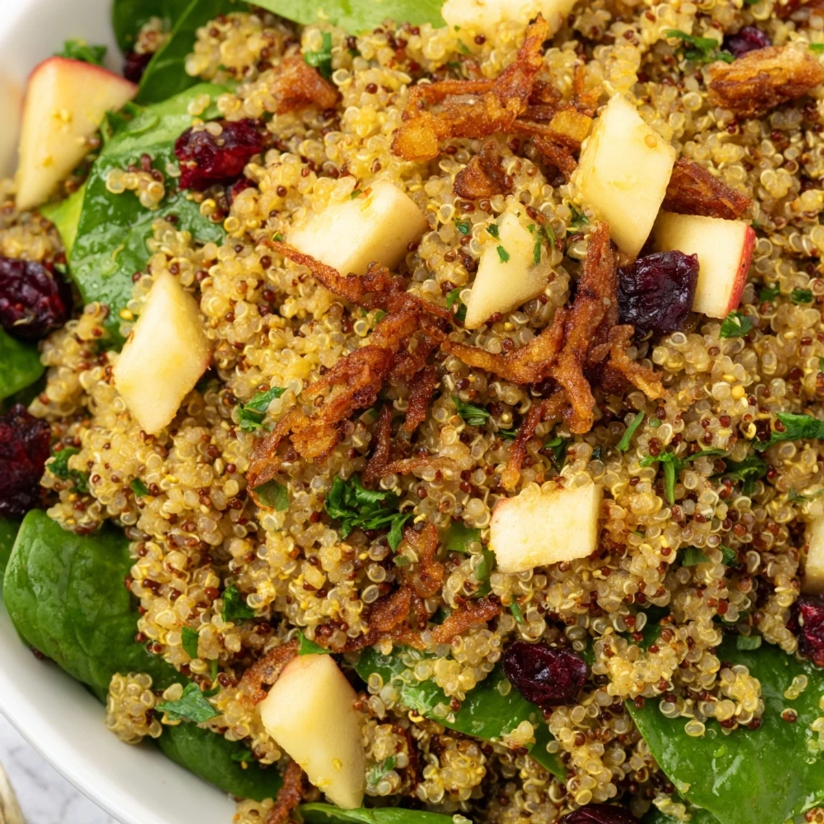 Vibrant honey mustard quinoa apple salad with toasted pecans and fried shallots plated fresh
