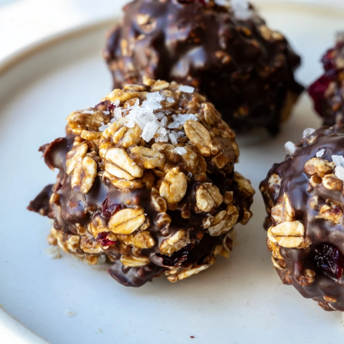 Dark chocolate Quinoa Crunch Bites topped with chopped almonds and dried cranberries