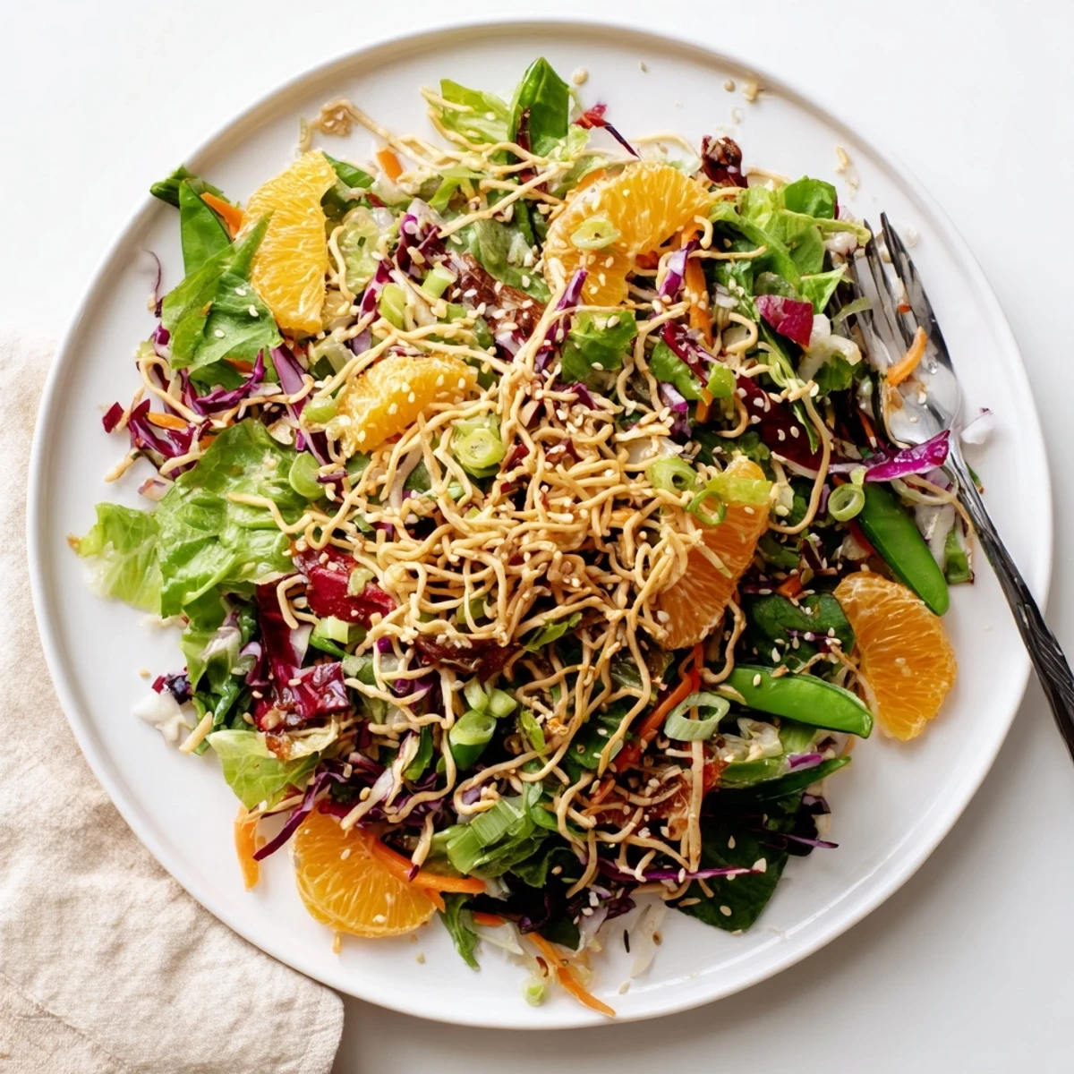 Colorful Mandarin Sesame Crunch Salad topped with golden toasted noodles and sweet orange segments