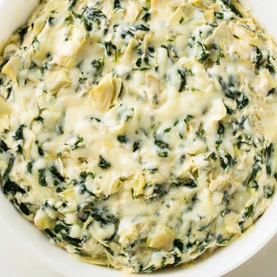 Fresh spinach and chopped artichokes peek through a rich, cheesy base in this irresistible appetizer.