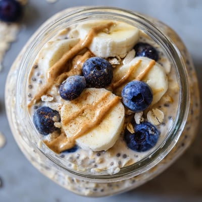 Thick protein overnight oats layered with sliced banana and chia seeds